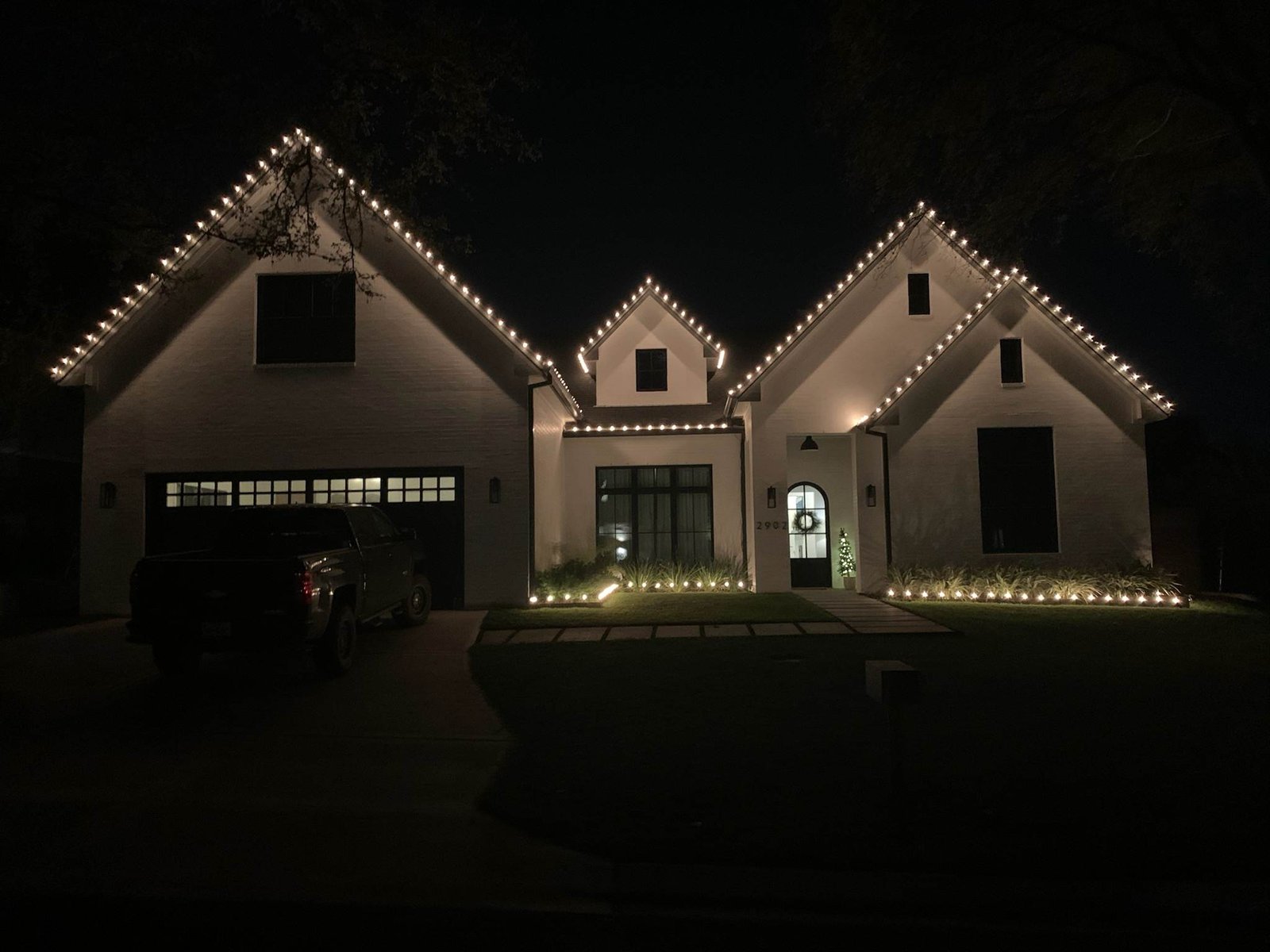 Colorful Christmas roofline light installation on a Texas home